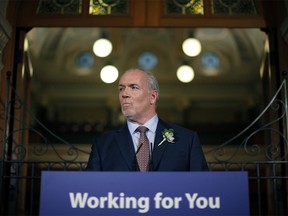 Premier John Horgan answers questions from the media following the speech from the throne in the legislative assembly in Victoria, B.C., on Tuesday, February 13, 2018.