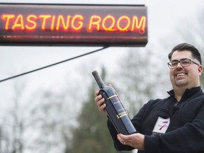 Jason Ocenas, manager of Township 7 Vineyards & Winery in Langley, holds a bottle of wine at the Langley tasting room.