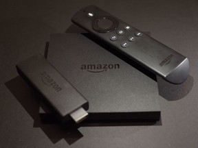 This November 2016 photo shows the Amazon Fire TV, centre, and Fire TV Stick, left, streaming television devices in New York.