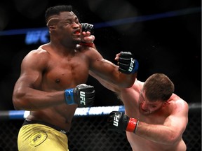 Stipe Miocic throws a punch against Francis Ngannou in their heavyweight championship fight during UFC 220 at TD Garden on Jan. 20 in Boston.