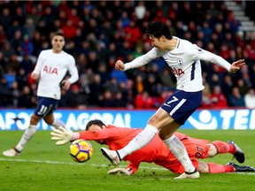 Heung-min Son of Tottenham Hotspur scores his side's third goal past Asmir Begovic of AFC Bournemouth during the Premier League match at Vitality Stadium on March 11 in Bournemouth, England.