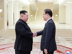 This picture taken on March 5, 2018 and released from North Korea's official Korean Central News Agency (KCNA) on March 6, 2018 shows North Korean leader Kim Jong-Un shaking hands with South Korean chief delegator Chung Eui-yong, who travelled as envoy of the South's President Moon Jae-in, during their meeting in Pyongyang.