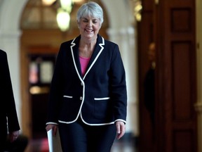 Finance Minister Carole James arrives at caucus before delivering the budget from the legislative assembly at Legislature in Victoria, B.C., on Tuesday, February 20, 2018.