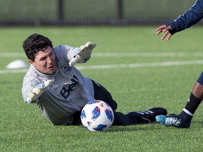 Whitecaps goalkeeper Brian Rowe makes a save during training at UBC.