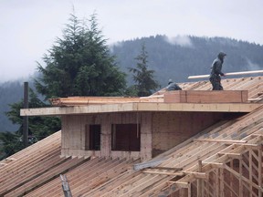 Builders work on a new home in North Vancouver on October 27, 2016.