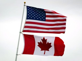 U.S. and Canadian flags fly in Point Roberts, Wash., on Tuesday, March 13, 2012.