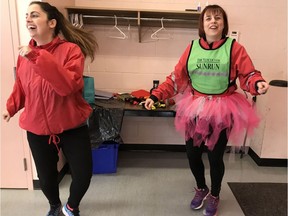 Sandra Jongs Sayer, the sophomore coordinator of the Langley Sun Run InTraining clinic, leads her crew through a fun warm-up before their Valentine's Day run at McLeod Athletic Park. Sayer's personal touch has proved popular with the group.