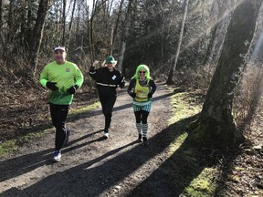 Debbie Elliott, right, a leader with the W.C. Blair Sun Run InTraining Clinic in Langley, got into the spirit of St. Patrick's Day when she worked out with runners at scenic Aldergrove Regional Park.