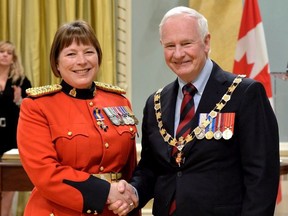Governor General David Johnston presents The Order of Merit of the Police Forces, Member insigna to Chief Superintendent Brenda M. Lucki, M.O.M., at Rideau Hall on May 24, 2013.