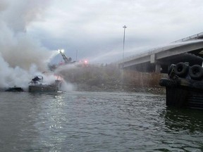 Port Coquitlam Fire and Emergency Services extinguish a boat fire under the Pitt River Bridge on Thursday morning.