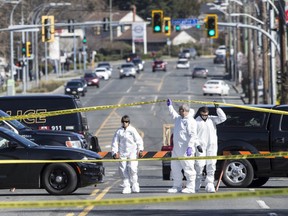 Forensic officers investigate a weekend incident on Hillside Avenue in Victoria that left Joe Gauthier dead.