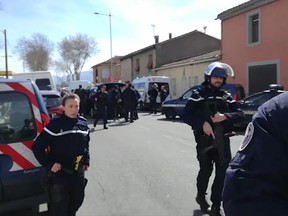 In this image taken from La Depeche Du Midi, police attend an incident in Trebes, southern France, Friday March 23, 2018.