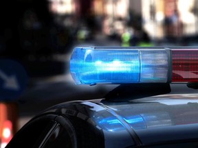 Police patrol car with flashing lights and siren on during the night raid against crime