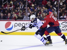 Winnipeg Jets star winger Patrik Laine (left) pulls ahead of Washington Capitals superstar Alex Ovechkin in a race for the puck during their March 12, 2018 NHL game at Capital One Arena in Washington, D.C.