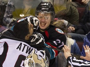 VANCOUVER. DECEMBER 28 2013.  Kelowna Rockets #27 Ryan Olsen knocks the helmet off Vancouver Giants #6 Arvin Atwal in third period WHL hockey action at the Pacific Coliseum, Vancouver, December 28 2013.    Gerry Kahrmann  /  PNG staff photo)