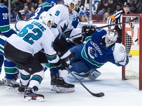 San Jose Sharks' Kevin Labanc (62) scores against Vancouver Canucks' goalie Jacob Markstrom, right, of Sweden, during the first period of Saturday's game.