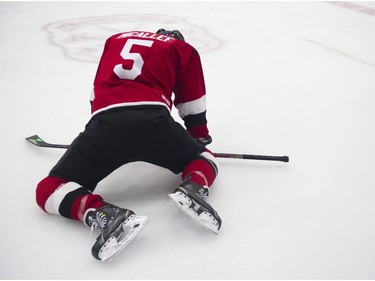 Victor Micallef of The Tenors stretches as Juno Cup players take to the ice for a practice at the Bill Copeland Sports Centre in Burnaby on March 22, 2018.