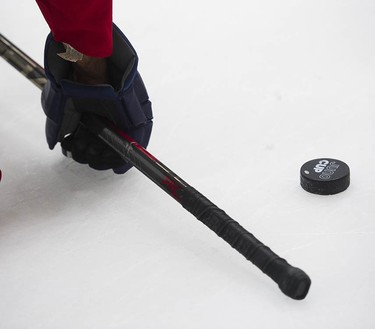 A Juno Cup puck sits on the ice as players take to the ice for a practice at the Bill Copeland Sports Centre in Burnaby on March 22, 2018.