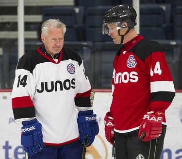 Barney Bentall chats with former NHLer B.J. MacDonald as the Juno Cup players take to the ice for a practice at the Bill Copeland Sports Centre in Burnaby on March 22, 2018.