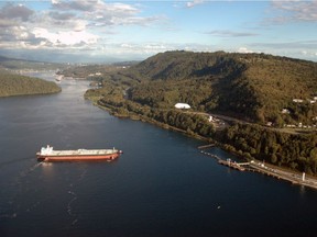 An oil tanker under tug control prepares to berth at Kinder Morgan's Westridge Marine Terminal in Burnaby.