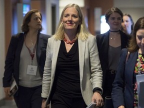 Minister of Environment and Climate Change, Catherine McKenna, centre, arrives to make an announcement in Vancouver, Wednesday, March 14, 2018.
