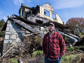 Mike McComb in front of the remains of his century-old home on McClure Street in Victoria that was destroyed by fire on March 19, 2018.