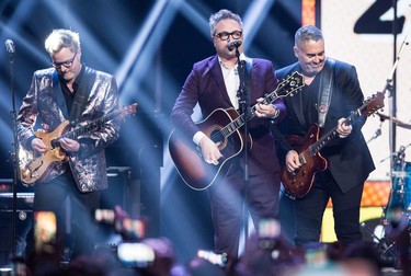 Kevin Hearn, left, and Ed Robertson, right, of the Barenaked Ladies, and former member and co-founder Steven Page, centre, perform during the Juno Awards in Vancouver, B.C., on Sunday March 25, 2018.