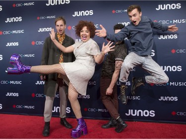 Jasmyn Burke, second from left, arrives with Weaves bandmates on the red carpet at the Juno Awards in Vancouver, Sunday, March, 25, 2018.