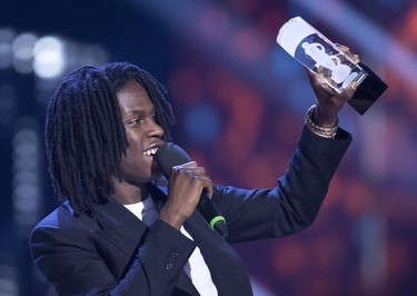 Daniel Caesar holds up his Juno award for R and B Soul Recording of the Year at the Juno Awards in Vancouver, Sunday, March, 25, 2018.