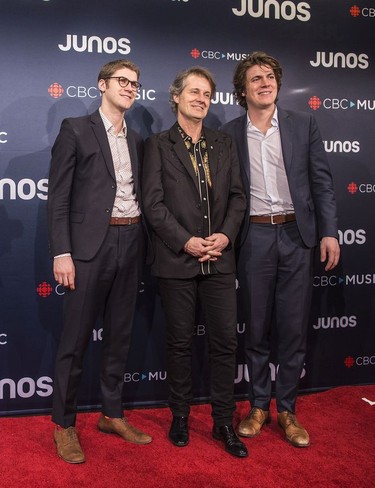 Jim Cuddy, centre, is seen with son Devin, right, and Sam Polley during arrivals for the 2018 Juno Awards, in Vancouver on Sunday, March 25, 2018.