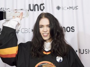 Grimes celebrates her Juno for Video of the Year at the Juno Awards in Vancouver on March 25.