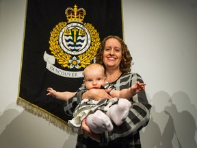 Emilie Stevens, carrying daughter Lily Coe, was honoured with the award of merit, the Vancouver Police Department's highest civilian honour, at the Roundhouse Community Centre on Thursday.