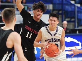 Vancouver College's Jack Cruz-Dumont, right, drives for the hoop past Terry Fox Ravens' Jacob Mand during Wednesday's action in the quad-A provincial boys' basketball Championship at the Langley Event Centre. Vancouver College defeated Terry Fox 79-63.