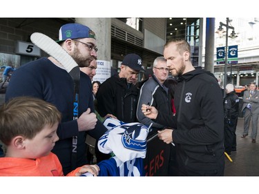 Vancouver Canucks Alexander Edler meets with fans prior to their NHL game against the Columbus Blue Jackets in Vancouver, BC, March, 31, 2018.