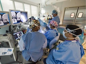 Dr. Javer (pink/white cap) and his team performs sinus surgery on a patient at False Creek Surgery Centre in Vancouver, B.C., April 20, 2017. The Canadian Centre for Policy Alternatives is opposed to private clinics doing more complex medical procedures.