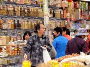 VANCOUVER, BC., June 4, 2017 – A man with shopping bags is pictured inside a Chinatown shop in Vancouver, B.C. City officials will deliver a formal apology next month for the historic discrimination of Vancouver's Chinese community.