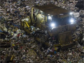 A front end loader moves garbage inside the pit at the Kent Avenue Transfer Station in Vancouver.
