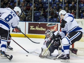 Victoria Royals Jeff de Wit and Andrei Grishakov get in close on Vancouver Giants goaltender Trent Miner in WHL playoff action at the Save-on-Foods Memorial Centre in Victoria on Saturday.