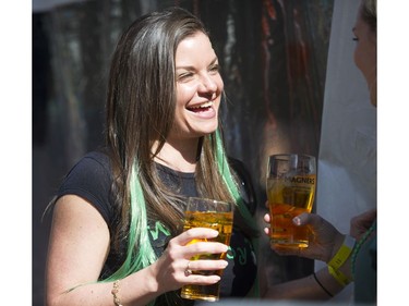 Ashley Adamson smiles as she has a cider with a friend at the St. Patrick's Day party at the Blarney Stone, Vancouver, March 17 2018.