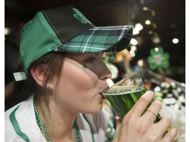 Kristy Learmont from Brisbane Australia sips a green beer as she attends the St. Patrick's Day party at the Blarney Stone, Vancouver, March 17 2018.