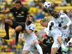 Vancouver Whitecaps forward Kei Kamara (23) heads the ball as midfielder Brek Shea (right) defends against Columbus Crew SC midfielder Artur (7) in the first half at MAPFRE Stadium.