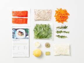Here’s what you can find inside a Fresh Prep meal kit: wild salmon, recipe card, organic quinoa, locally sourced arugula, garlic, herbs, lemon, soup stock cube, locally sourced shredded carrot, organic rosemary and chopped onions.