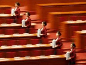 Workers prepare for the closing session of the annual National People's Congress in Beijing's Great Hall of the People in Beijing, China, Tuesday, March 20, 2018.