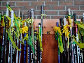Display of hockey sticks outside outside the Nicholas Sheran Ice centre in Lethbridge, Alta., on Saturday April 14, 2018, for Logan Boulet's funeral. Leah Hennel/Postmedia