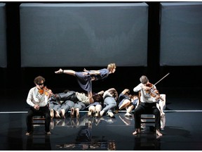 Blindfolded musicians of the Debussy Quartet perform as company members perform acrobatics in Circa: Opus.