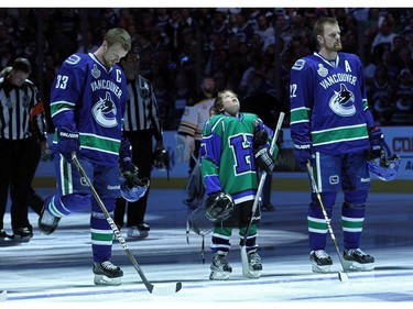JUNE 01:  Henrik Sedin (L) #33 and Daniel Sedin (R) #22 of the Vancouver Canucks stand on the ice prior to game one against the Boston Bruins in the 2011 NHL Stanley Cup Finals at Rogers Arena