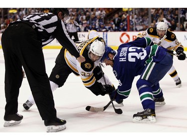 JUNE 15:  Patrice Bergeron #37 of the Boston Bruins faces off against Henrik Sedin #33 of the Vancouver Canucks during Game Seven of the 2011 NHL Stanley Cup Final at Rogers Arena.