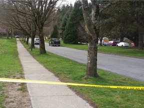 Police had blocked off West King Edward Avenue at Wallace Street in Vancouver's Dunbar neighbourhood after a man and his car drove into the woods west of Crown Street on Monday afternoon. [PNG Merlin Archive]