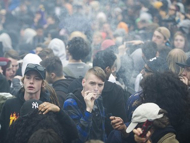 Cannabis enthusiasts create a cloud of smoke as they light up at Sunset Beach for the annual 4/20 protest in Vancouver.
