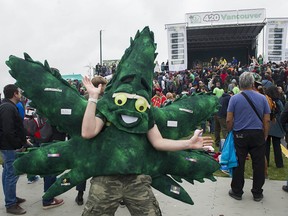 A man dressed as a marijuana leaf dances in front of the stage during the annual 4/20 protest at Sunset Beach in Vancouver.